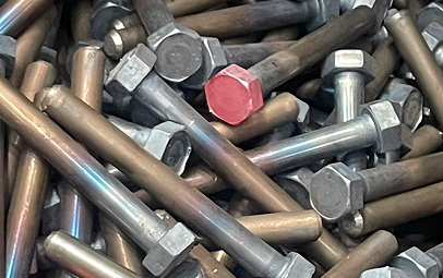 A Close Up Of Assorted Metal Nuts And Bolts Arranged Around A Prominent Red Button