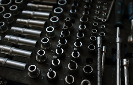 A Collection Of Various Tools Neatly Arranged On A Wooden Table