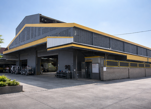 A Large Building Featuring A Distinctive Yellow And Gray Roof